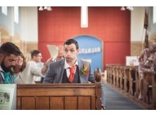 Documentary wedding photography of nervous groom in church wedding ceremony